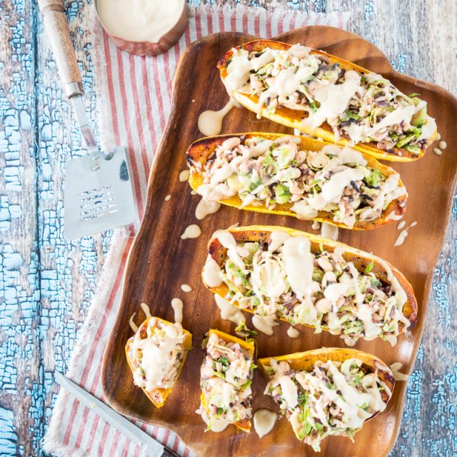 White Bean and Brussels Sprouts Stuffed Delicata Squash with Lemon Tahini Sauce