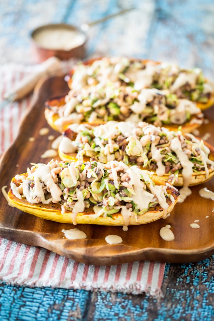 White Bean and Brussels Sprouts Stuffed Delicata Squash with Lemon Tahini Sauce