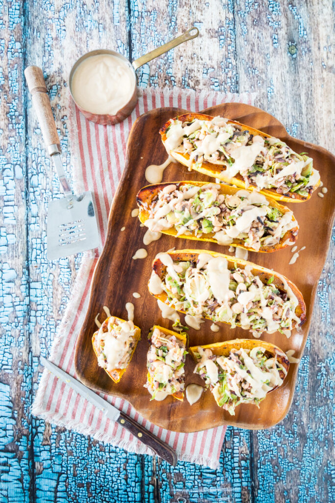 White Bean and Brussels Sprouts Stuffed Delicata Squash with Lemon Tahini Sauce