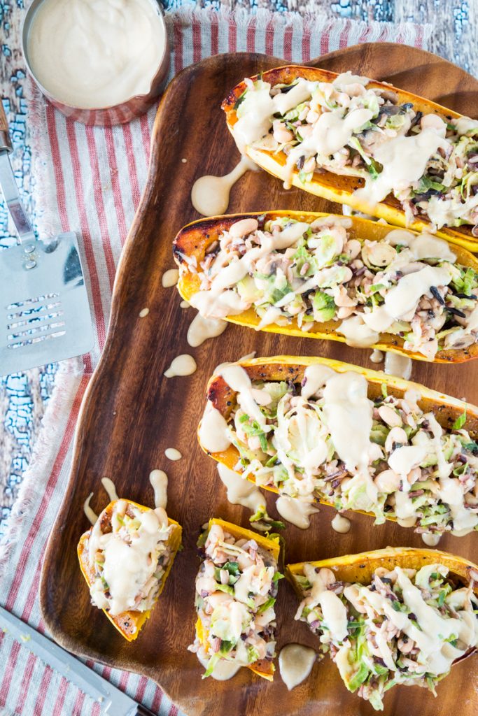 White Bean and Brussels Sprouts Stuffed Delicata Squash with Lemon Tahini Sauce