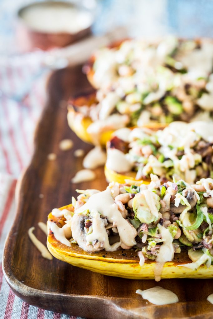 White Bean and Brussels Sprouts Stuffed Delicata Squash with Lemon Tahini Sauce