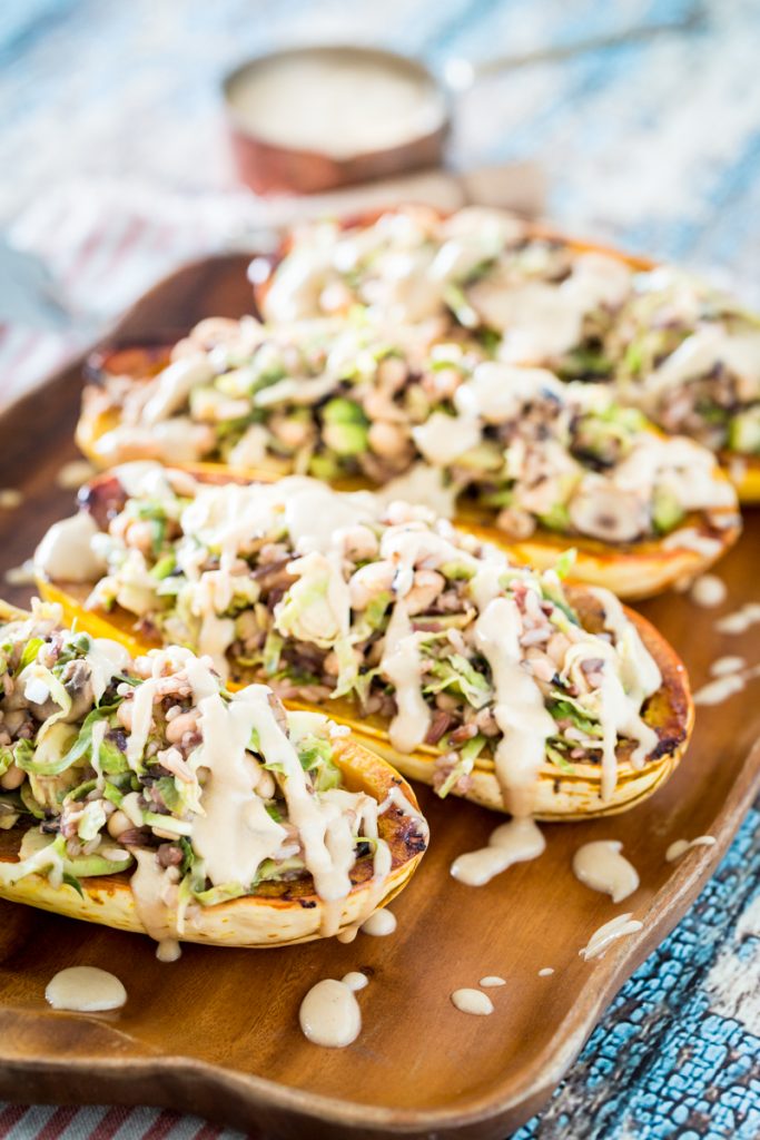 White Bean and Brussels Sprouts Stuffed Delicata Squash with Lemon Tahini Sauce