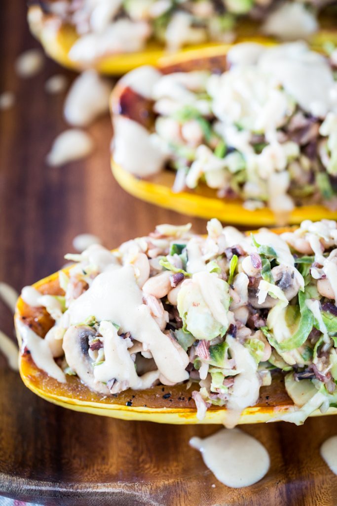 White Bean and Brussels Sprouts Stuffed Delicata Squash with Lemon Tahini Sauce