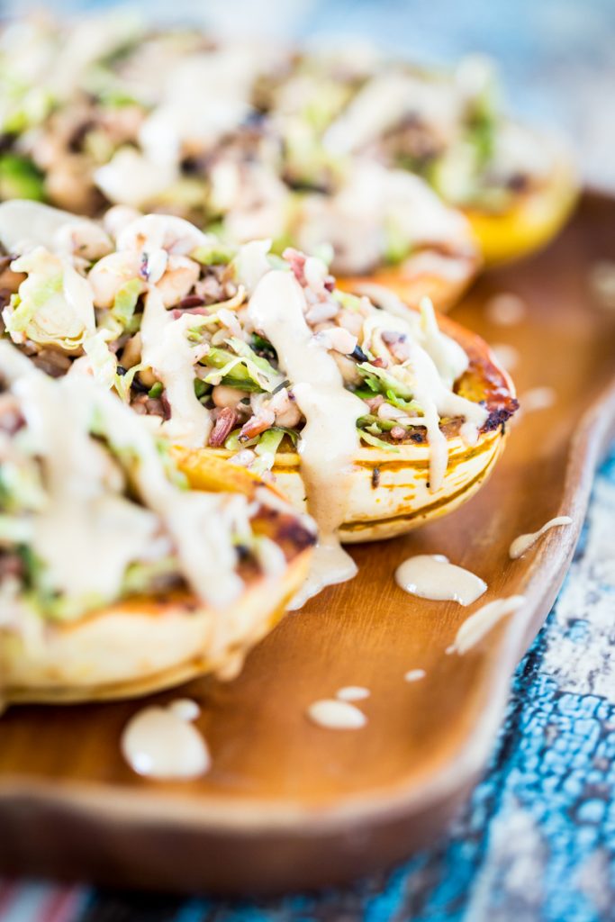 White Bean and Brussels Sprouts Stuffed Delicata Squash with Lemon Tahini Sauce