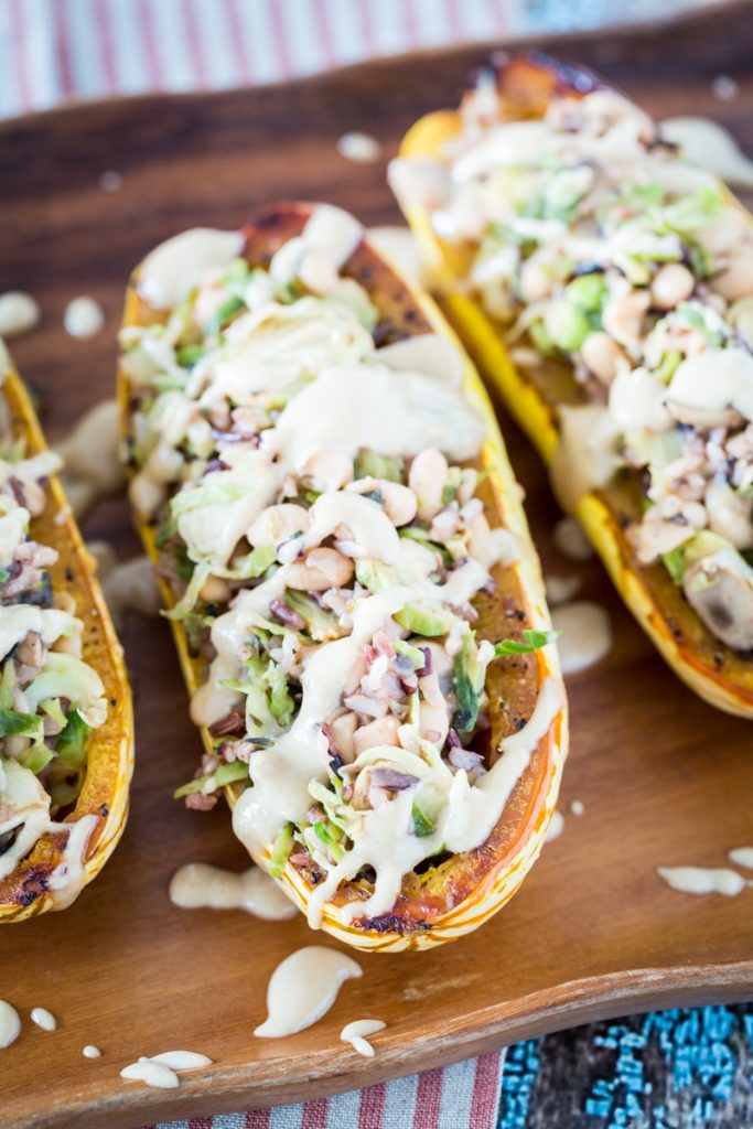 White Bean and Brussels Sprouts Stuffed Delicata Squash with Lemon Tahini Sauce