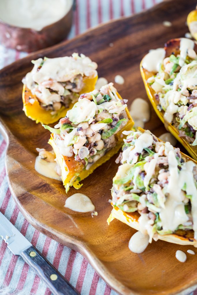 White Bean and Brussels Sprouts Stuffed Delicata Squash with Lemon Tahini Sauce